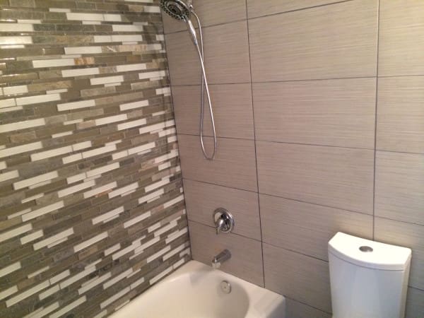 Finished bathroom with tile surround and new fixtures